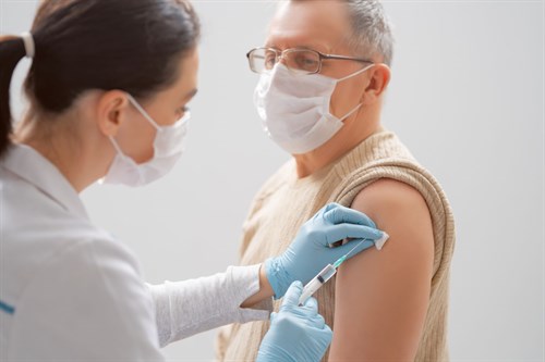 Doctor Giving A Senior Man A Vaccination